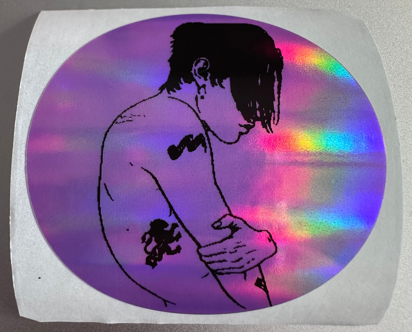 Holographic sticker with a silhouette of a person on a reflective surface