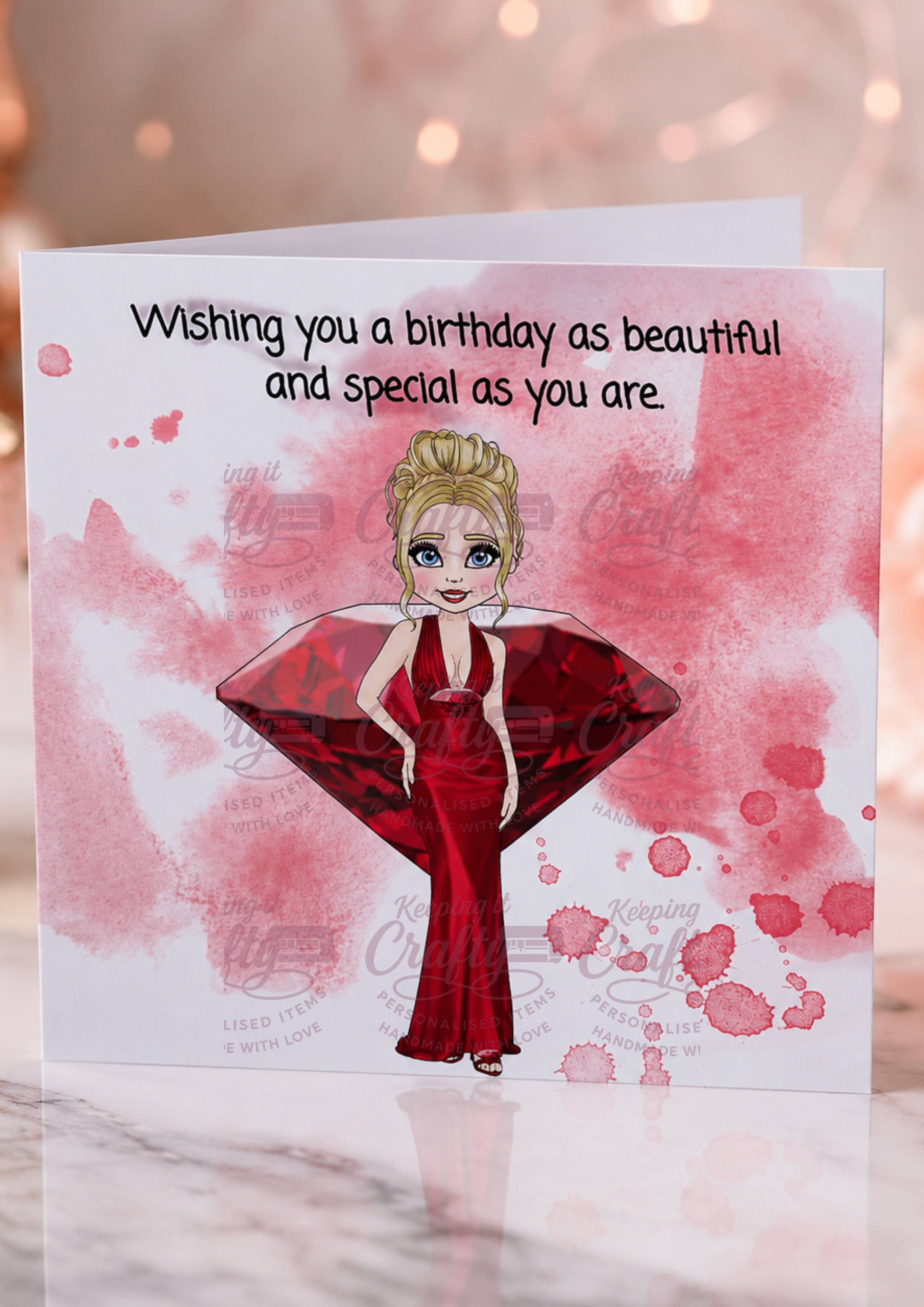A birthday greeting card featuring an illustration of a woman in a red dress holding a large red gem, with the text 'Wishing you a birthday as beautiful and special as you are' on a pink watercolor background.