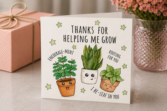 Greeting card with cartoon plants and text on a table with a gift and flowers.